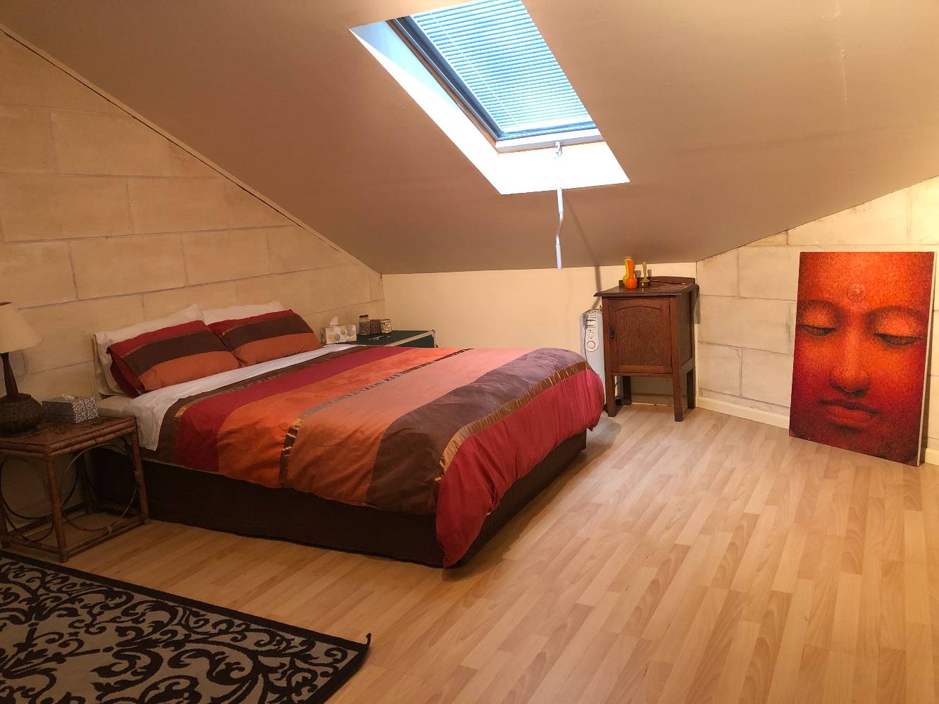 Loft bedroom with queen and king single beds.