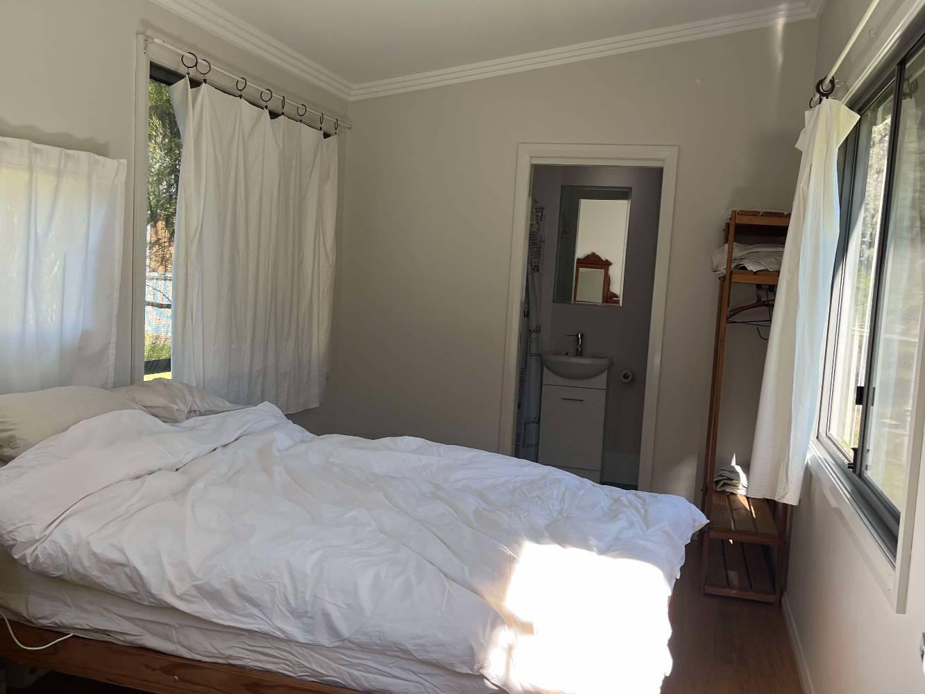 Smaller bedroom with ensuite and a double bed, just off the back veranda.