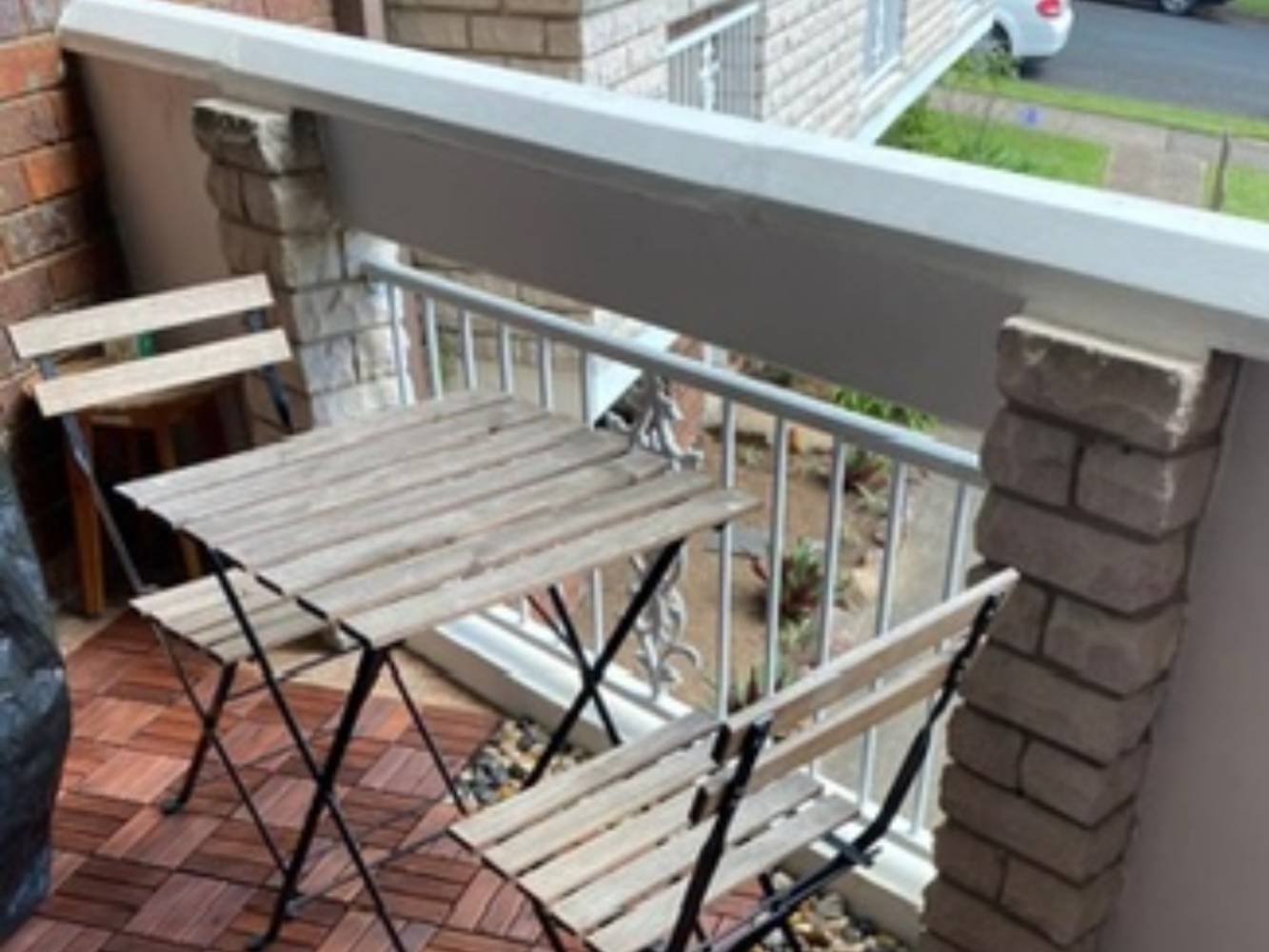 Balcony with bbq and seating and water glimpses