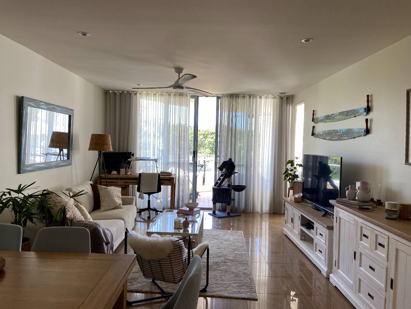 View from kitchen through living/dining area to balcony