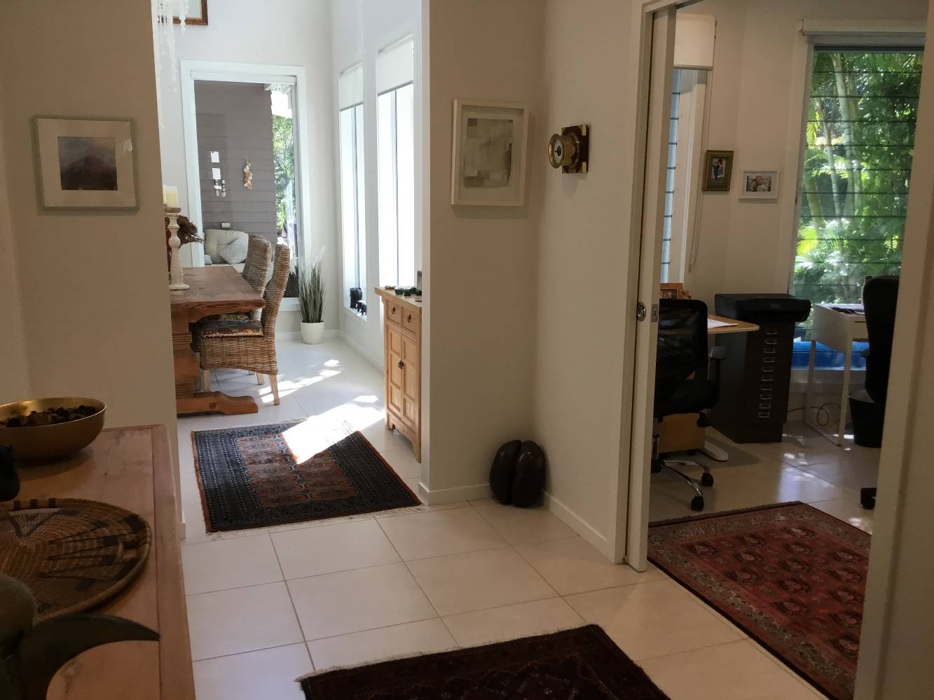 Entrance hall, study on right, looking through to internal dining area, outside patio and pool beyond